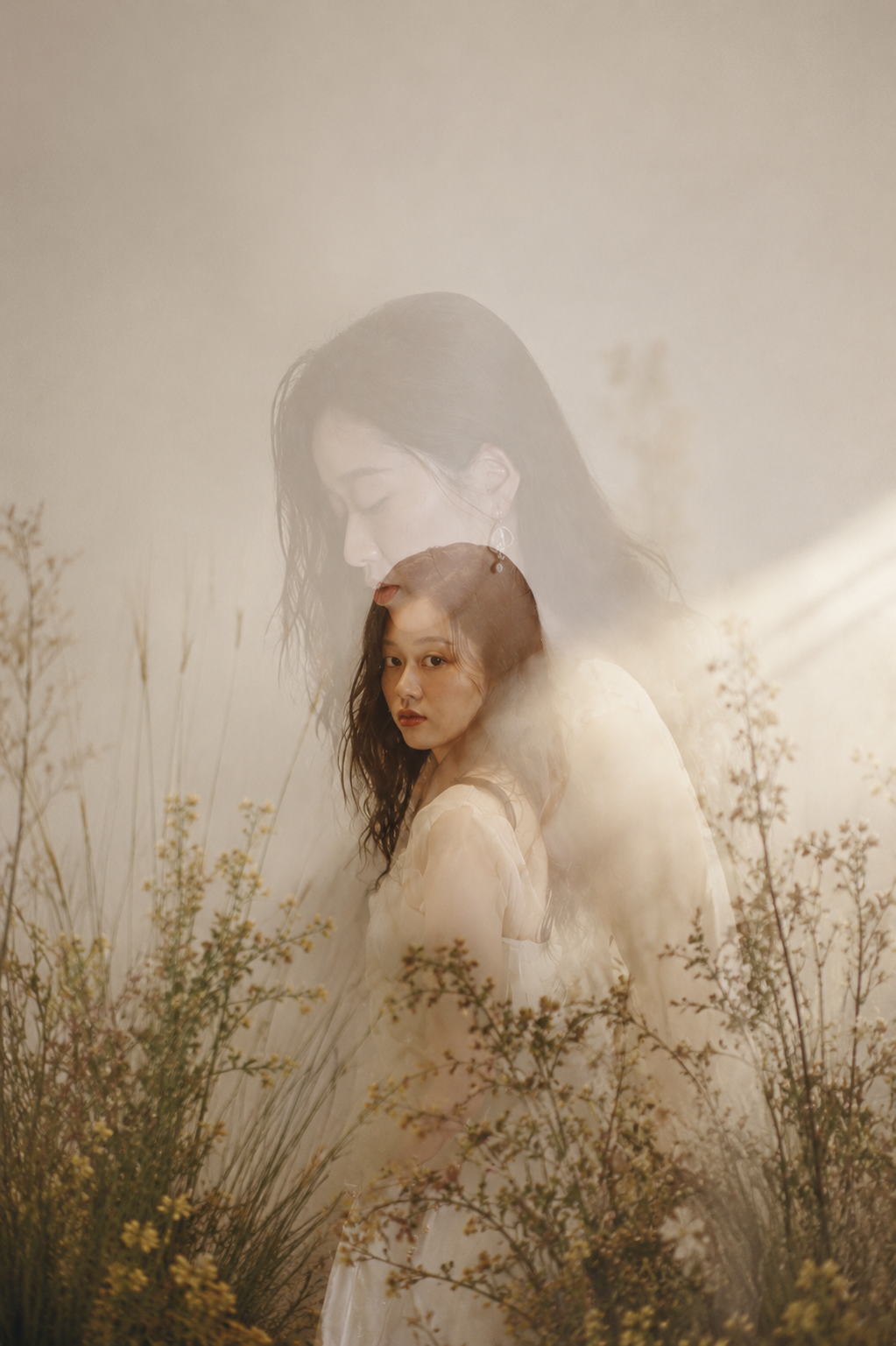 Double exposure portrait of Cher Yuan among flowers and daylight